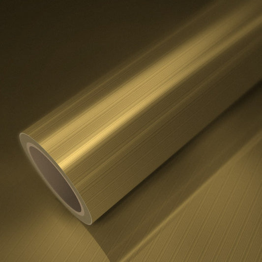 Rolo de vinil dourado escovado sobre uma folha do mesmo vinil