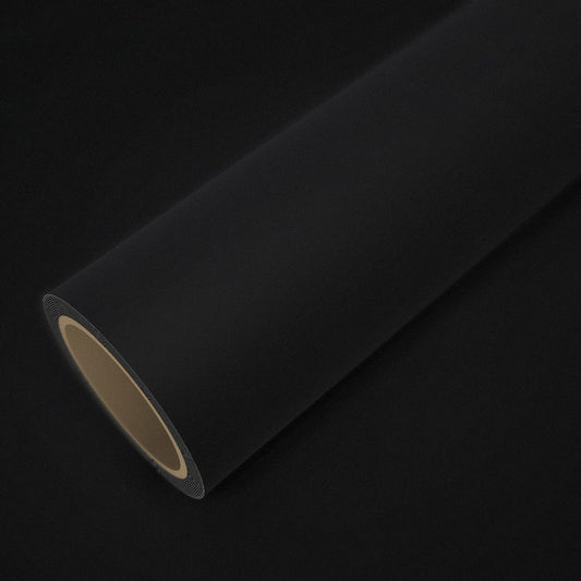 Rolo de vinil preto mate sobre uma folha do mesmo vinil